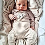 baby, infant, child, blanket, knit_pants, hat, cozy, soft, cute, portrait, lying_down, beige, warm_colors, newborn, clothing, sleepwear, toddler, face, hand, foot