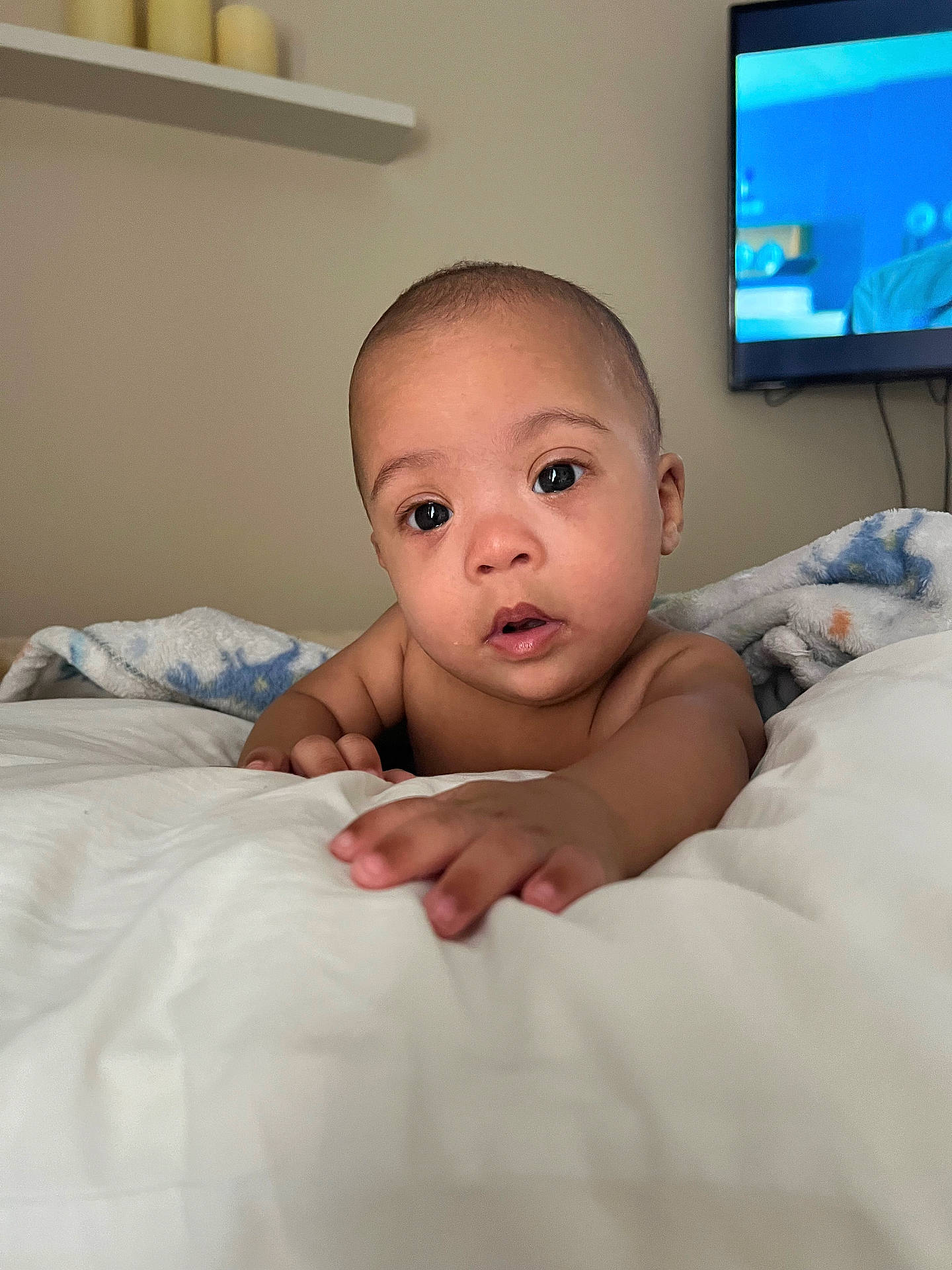 Tristan is registered to the contest to win money with this photo: baby, bed, bedroom, blanket, bodypart, computerhardware, electronics, face, finger, furniture, hand, hardware, head, indoors, monitor, person, photography, portrait, screen, tv