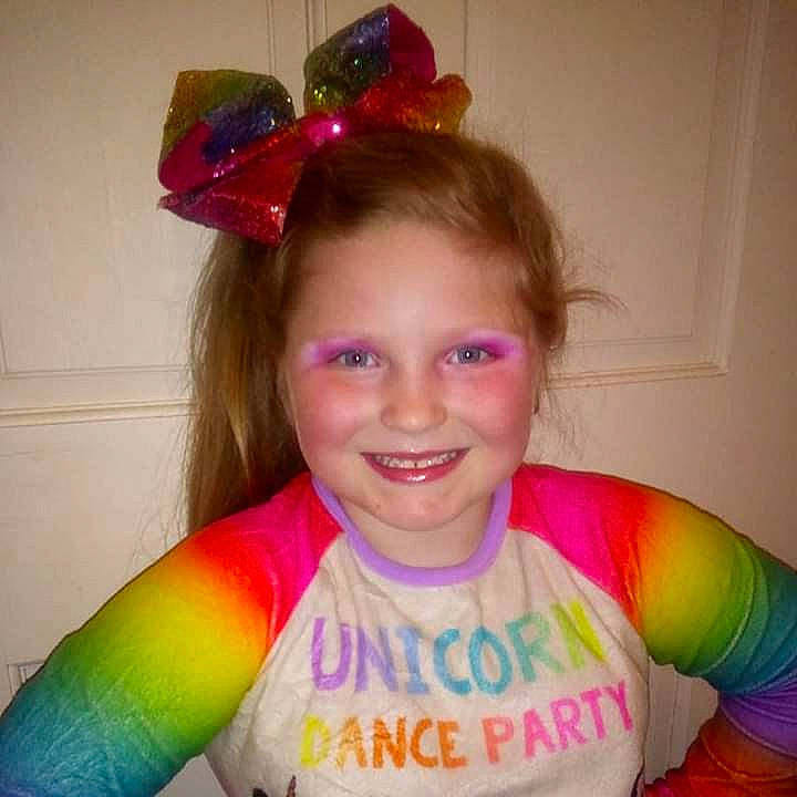 Preslee is registered to the contest to win money with this photo: child, ear, face, fashion_accessory, fun, hair, hair_accessory, hair_coloring, happy, head, headband, headgear, joy, lip, person, pink, play, smile, toddler