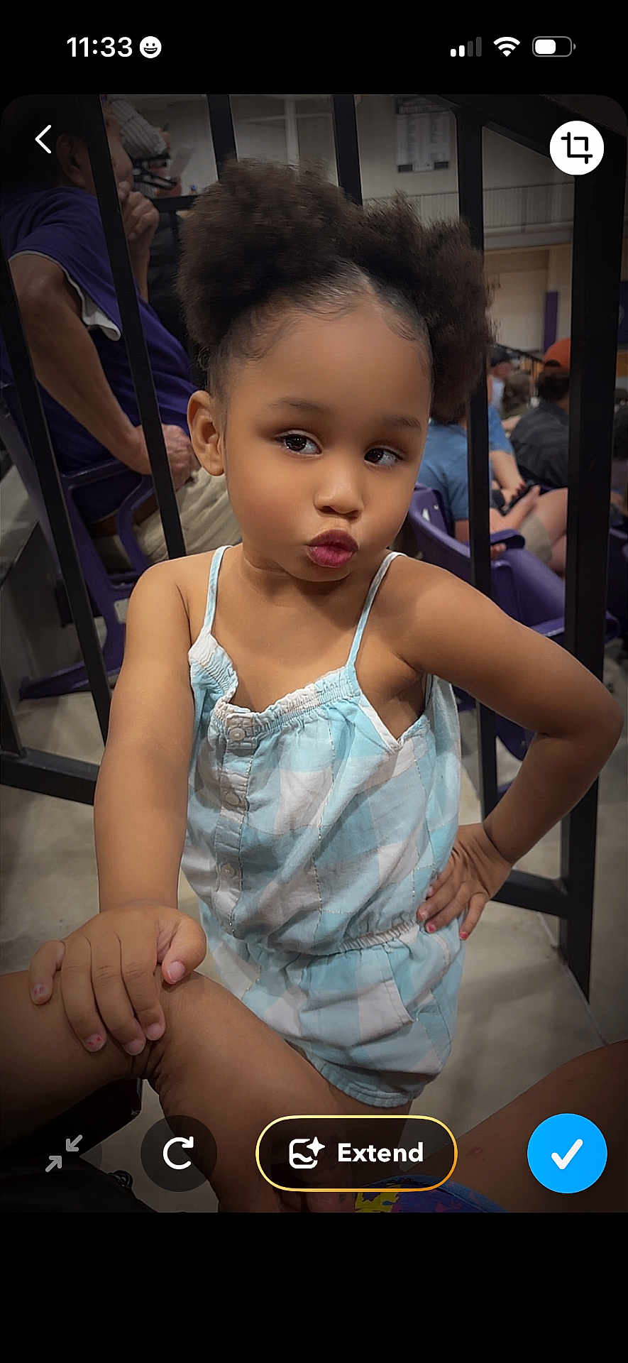 Journey is registered to the contest to win money with this photo: child, girl, posing, pout, blue_outfit, checkered_clothing, indoor, people, seated, railing, hand_on_hip, cute, confident, hairstyle, curly_hair, casual, nail_polish, expression, portrait, person