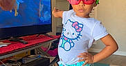 Journey joined the competition — help win amazing prizes! child, girl, indoor, standing, pose, hello_kitty, tshirt, shorts, sunglasses, sneakers, hair_beads, colorful, rug, television, animation, living_room, clock, shelf, confident, cute