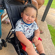 Ezekiel joined the competition — help win amazing prizes! baby, stroller, child, smile, keys, outdoor, concrete, grass, person, tattoo, legs, clothing, shoes, seat, hand, footwear, sunlight, playful, cute, infant