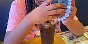 Aliyah is registered to the contest to win money with this photo: adult, bodypart, child, electronics, face, female, furniture, girl, head, indoors, mobilephone, pen, person, phone, photography, portrait, restaurant, table, woman, wood