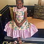Aliyah joined the competition — help win amazing prizes! accessories, child, clothing, couch, dress, face, female, footwear, furniture, girl, head, jewelry, necklace, person, photography, portrait, sandal, sitting, skirt, sleeve
