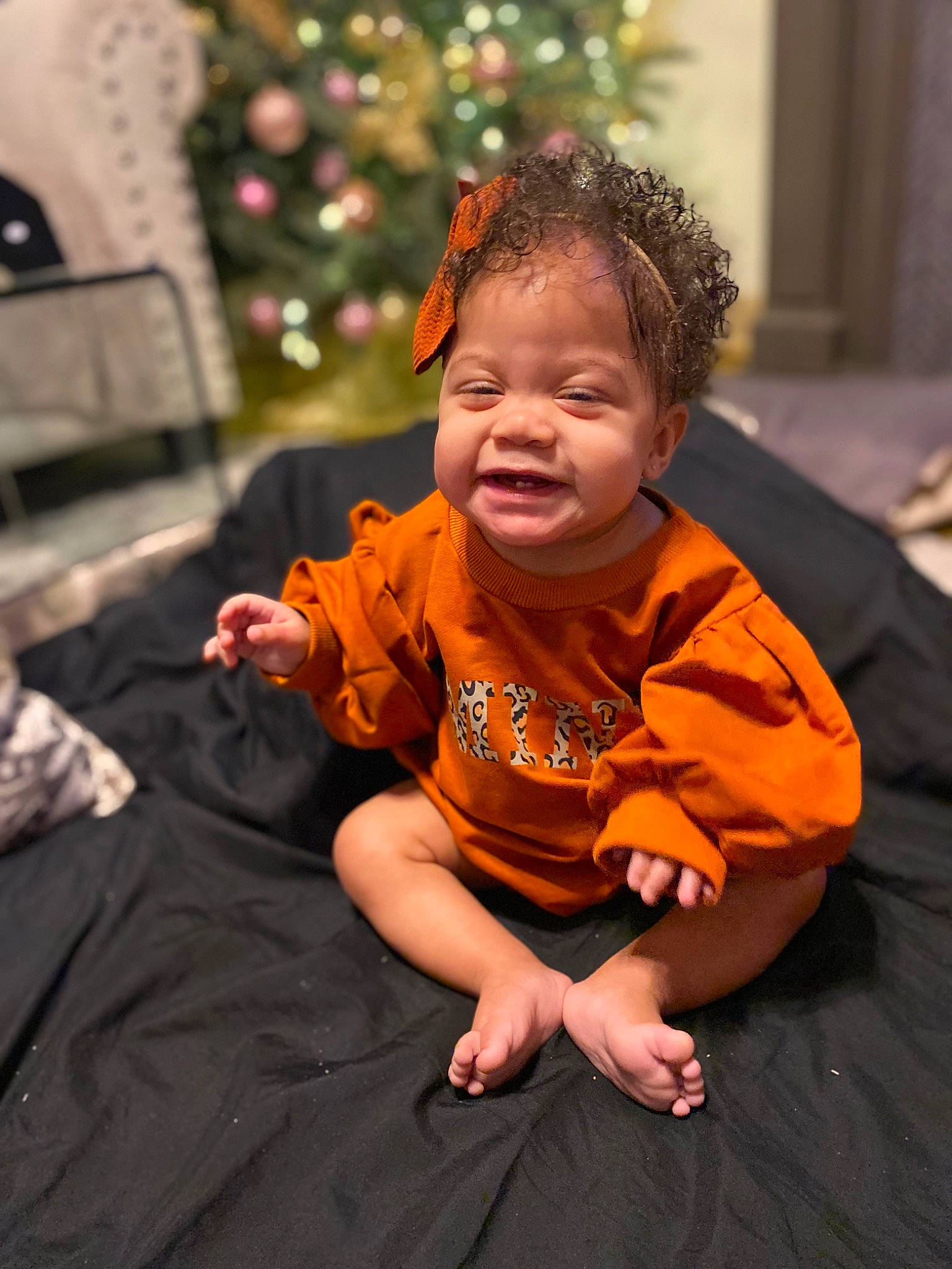 Khali joined the competition — help win amazing prizes! baby, child, christmas_tree, event, eye, face, flooring, fun, grass, happy, holiday, leisure, ornament, person, room, sitting, t_shirt, toddler, tradition, tree
