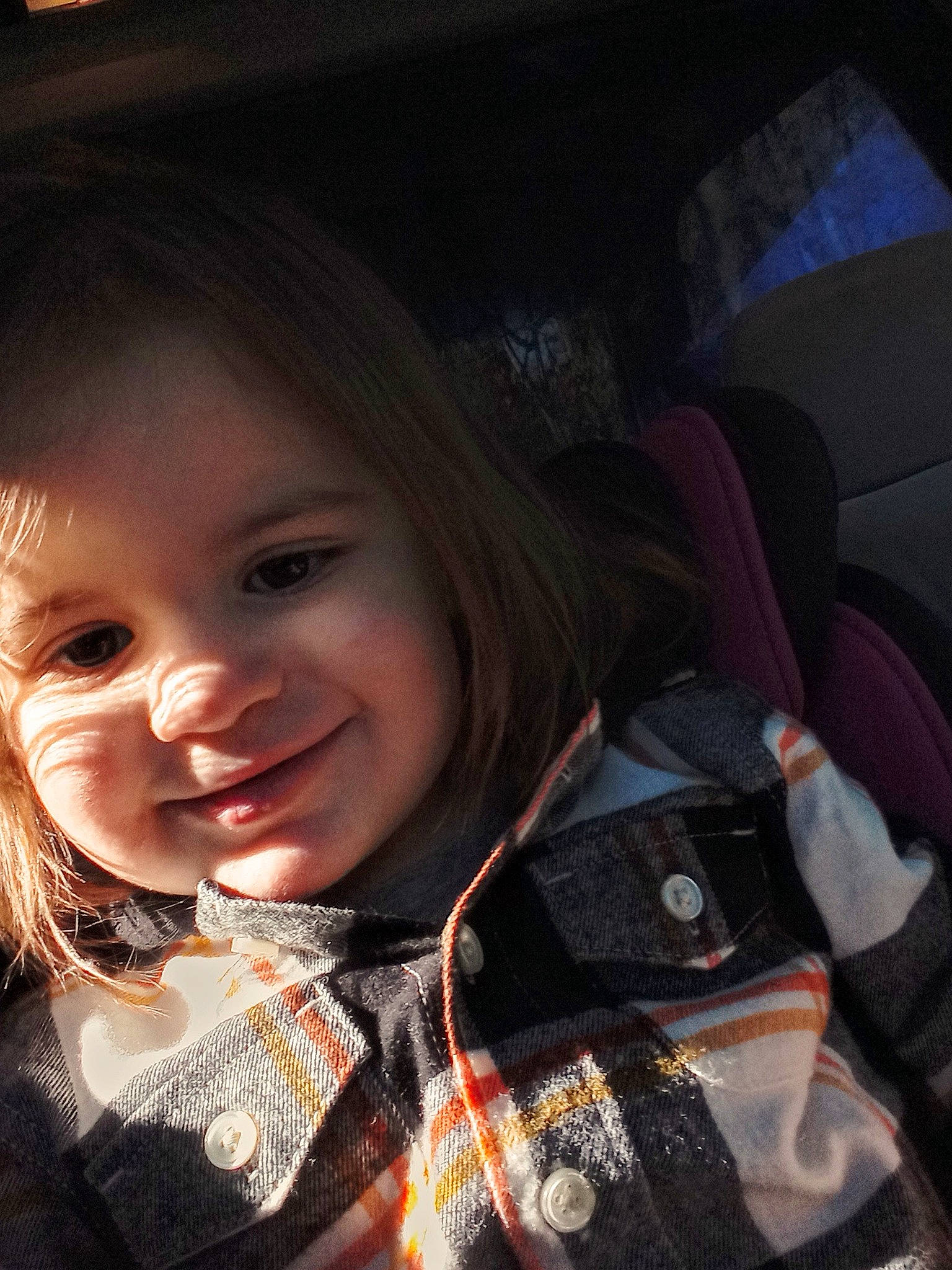 Amelia is registered to the contest to win money with this photo: automotive_lighting, child, chin, cool, family_car, fashion_accessory, flash_photography, fun, happy, iris, jewellery, joy, lip, nose, pattern, person, plaid, skin, smile, toddler