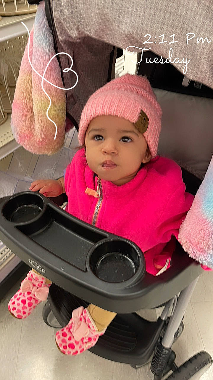 Zakiyah joined the competition — help win amazing prizes! auto_part, baby, baby_carriage, baby_products, baby_safety, baby_toddler_clothing, cap, car_seat, carmine, cheek, child, comfort, cool, facial_expression, fashion_accessory, headwear, magenta, person, pink, product
