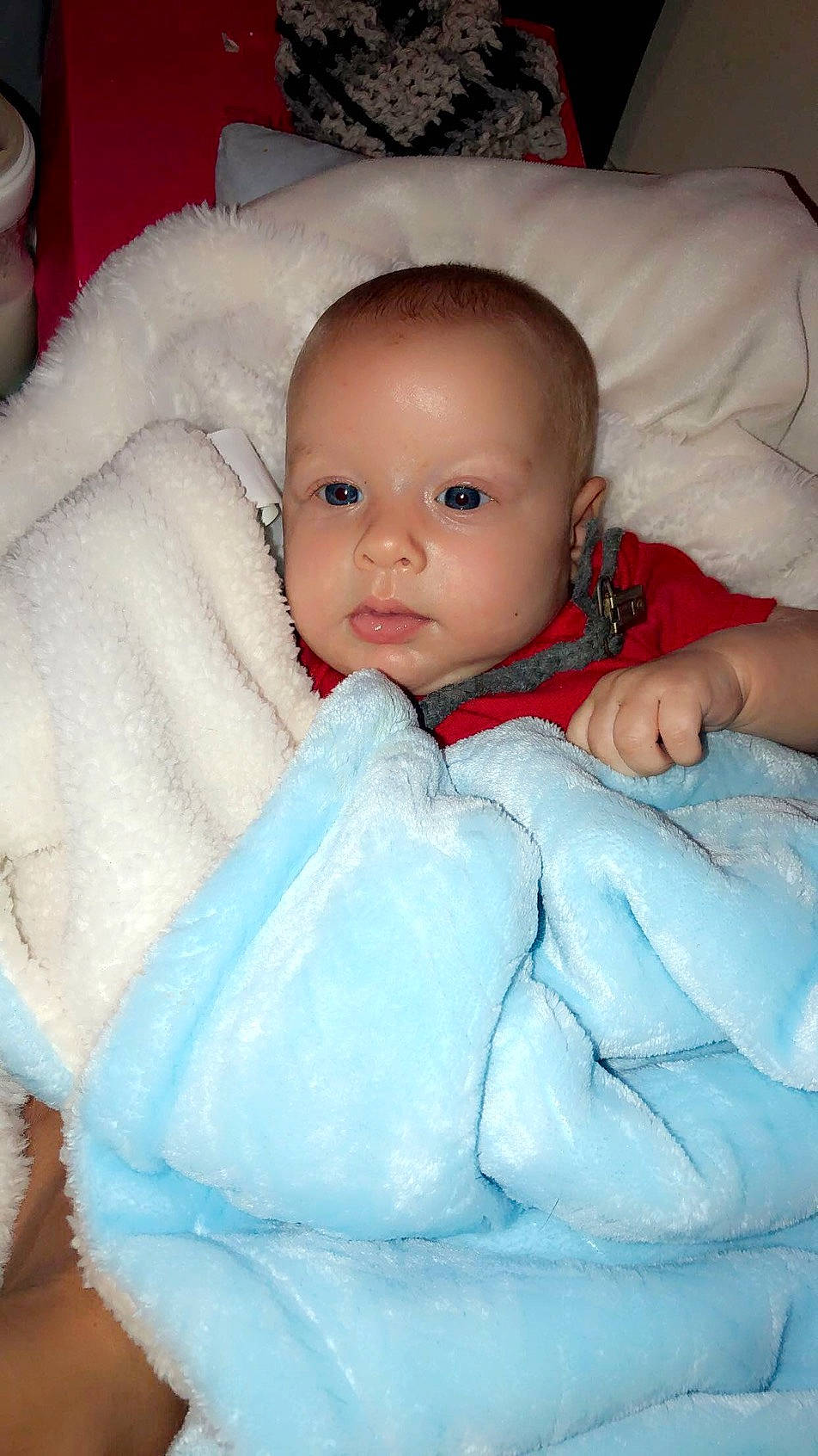 Travis is registered to the contest to win money with this photo: baby, baby_toddler_clothing, cheek, child, chin, comfort, electric_blue, eye, face, happy, head, iris, linens, lip, nose, person, product, sitting, skin, sleeve