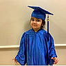Aarya joined the competition — help win amazing prizes! child, graduation, blue_gown, cap, portrait, smile, indoor, young, celebration, person, face, headwear, clothing, happy, cute, formal, event, kid, standing, background