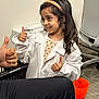 Aadya joined the competition — help win amazing prizes! child, girl, thumbs_up, white_lab_coat, smiling, headband, indoor, office_chair, orange_bucket, carpet, long_hair, person, adult_hand, interaction, happy, polka_dot, sleeve, seated, desk_chair, box