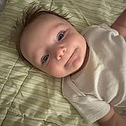 Denise joined the competition — help win amazing prizes! baby, infant, smile, blue_eyes, white_clothing, striped_blanket, lying_down, cute, portrait, face, child, soft_lighting, indoors, happy, young, skin, head, expression, toddler, person