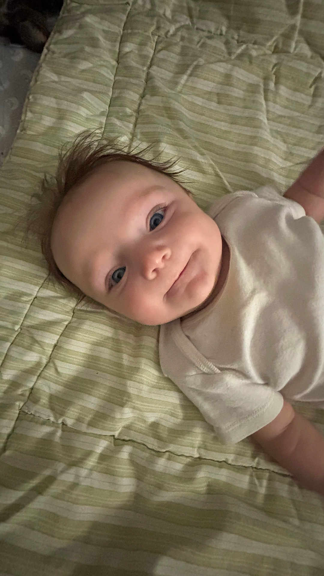 Denise joined the competition — help win amazing prizes! baby, infant, smile, blue_eyes, white_clothing, striped_blanket, lying_down, cute, portrait, face, child, soft_lighting, indoors, happy, young, skin, head, expression, toddler, person