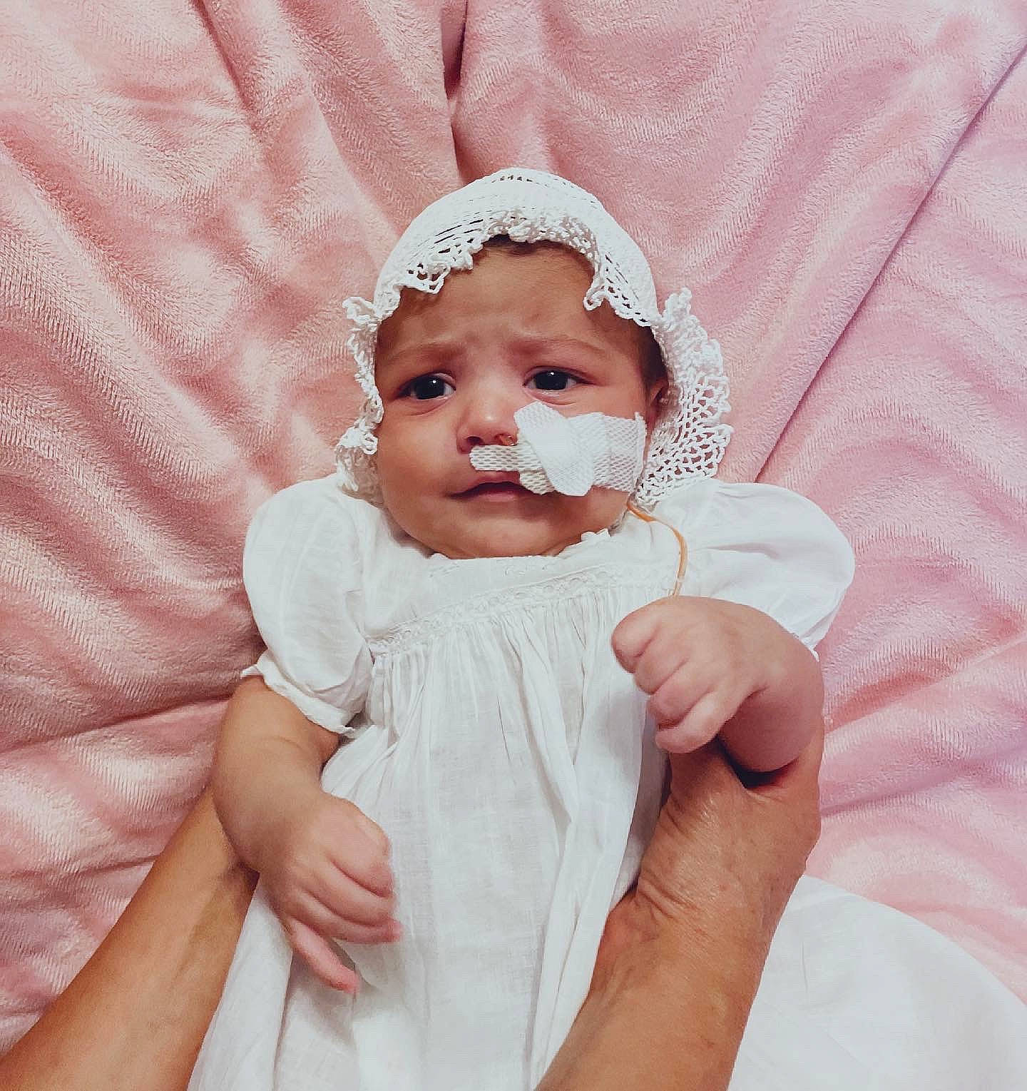 Esme joined the competition — help win amazing prizes! baby, baby_toddler_clothing, cheek, dress, eye, eyebrow, eyelash, face, finger, gesture, hair, hand, happy, head, headwear, lip, neck, person, pink, skin