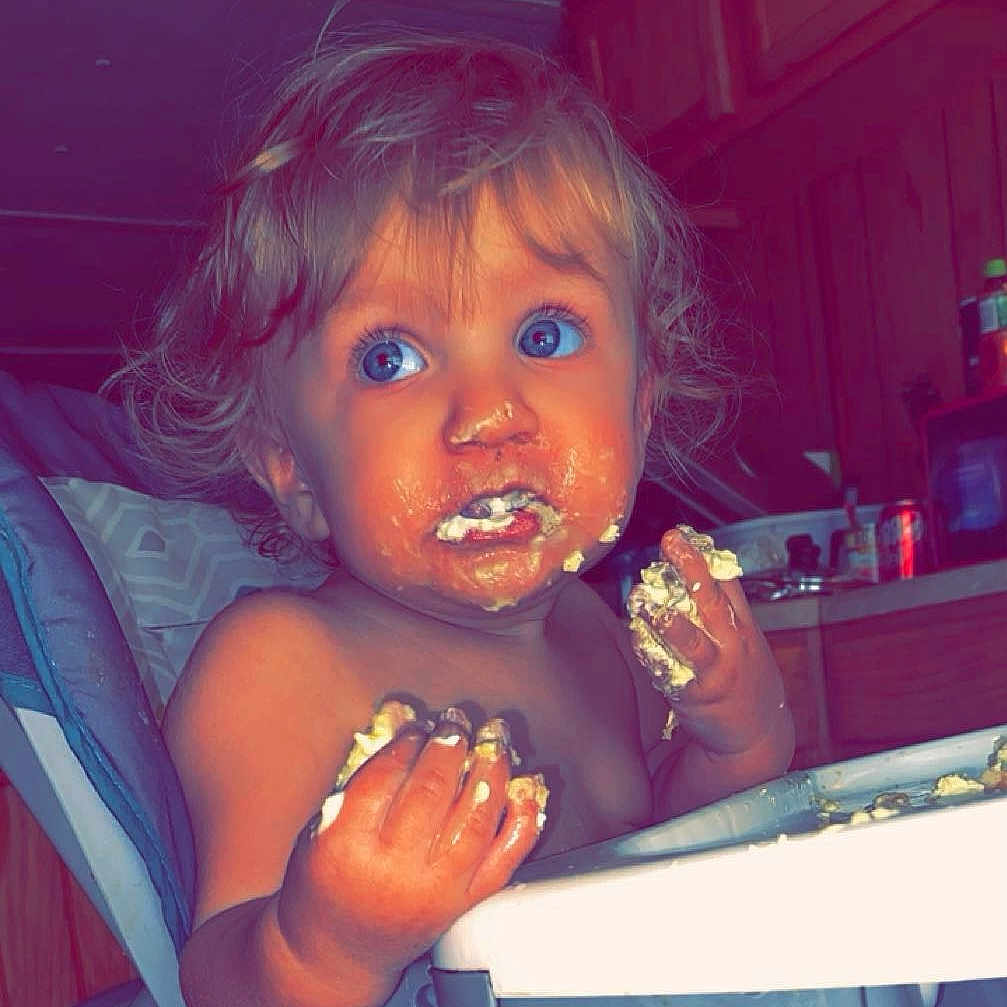 Jackson is registered to the contest to win money with this photo: baby, biting, couch, cream, cutlery, dessert, dish, eating, face, food, furniture, head, icecream, icing, meal, person, photography, portrait, spoon