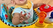Athalia joined the competition — help win amazing prizes! baby, baby_toy, child, clothing, colorful, expression, face, flooring, hand, happy, indoor, infant, joy, person, play, reaching, seat, smiling, toy, walker