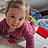 Emy a rejoint le concours — aidez-le/la à gagner de superbes lots ! baby, carpet, child, colorful, crawling, curious, expression, face, floor, happy, head, indoor, person, pink_clothing, playroom, playtime, smiling, toddler, toys, young_child