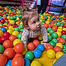 active, adult, ball_pit, bright_colors, casual_clothing, child, colorful_balls, crawling, curly_hair, family, fun, happy, indoor_play_area, leisure, person, play, playground, recreation, toddler, young_child