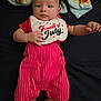 baby, infant, child, clothing, bib, red, white, striped, blanket, lying_down, looking_at_camera, cute, small_hands, face, expression, indoors, fabric, soft, person, newborn