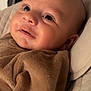 Kurtys a rejoint le concours — aidez-le/la à gagner de superbes lots ! baby, infant, smiling, face, blanket, brown, close_up, cute, child, soft, cushion, resting, indoors, portrait, young, skin, eyes, head, warm, comfort