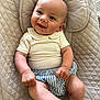 baby, smiling, infant, child, clothing, seat, quilted, beige, striped_shorts, cute_collar, happy, portrait, indoors, skin, hand, foot, head, face, person, comfortable
