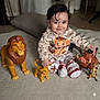 baby, big_eyes, brown_hair, carpet, child, cushion, cute, indoor, lion_toy, living_room, pajamas, playtime, pumbaa_toy, simba_toy, sitting, smile, socks, timon_toy, toddler, toy