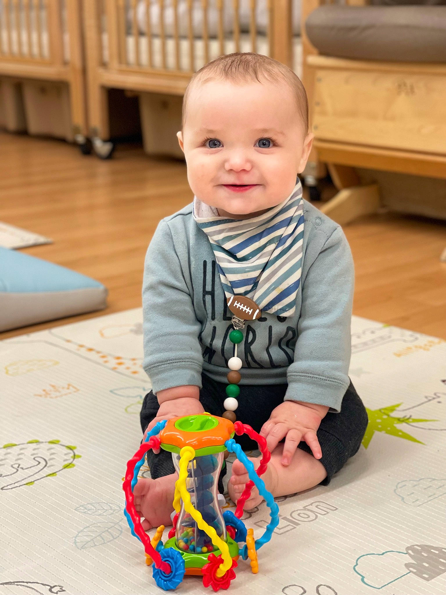 Connor is registered to the contest to win money with this photo: baby, baby_toddler_clothing, baby_toys, cheek, child, flooring, fun, happy, hardwood, joy, pattern, people, person, play, room, sitting, sleeve, smile, toddler, toy