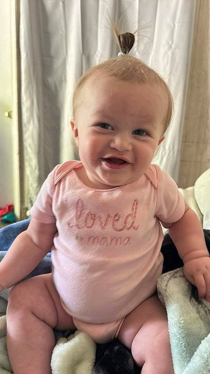 Isabella is registered to the contest to win money with this photo: baby, baby_toddler_clothing, cheek, chin, eye, face, facial_expression, hand, happy, head, human_body, joint, joy, lip, mouth, neck, person, shoulder, skin, sleeve