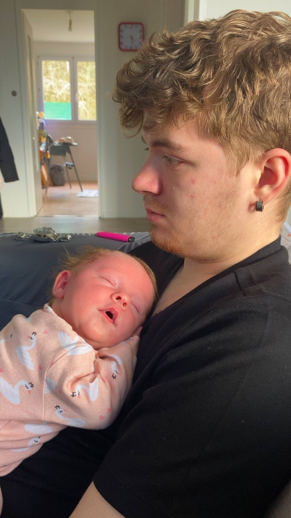 accessories, adult, architecture, baby, building, clothing, couch, earring, face, furniture, glasses, head, jewelry, male, man, newborn, person, photography, portrait, t_shirt