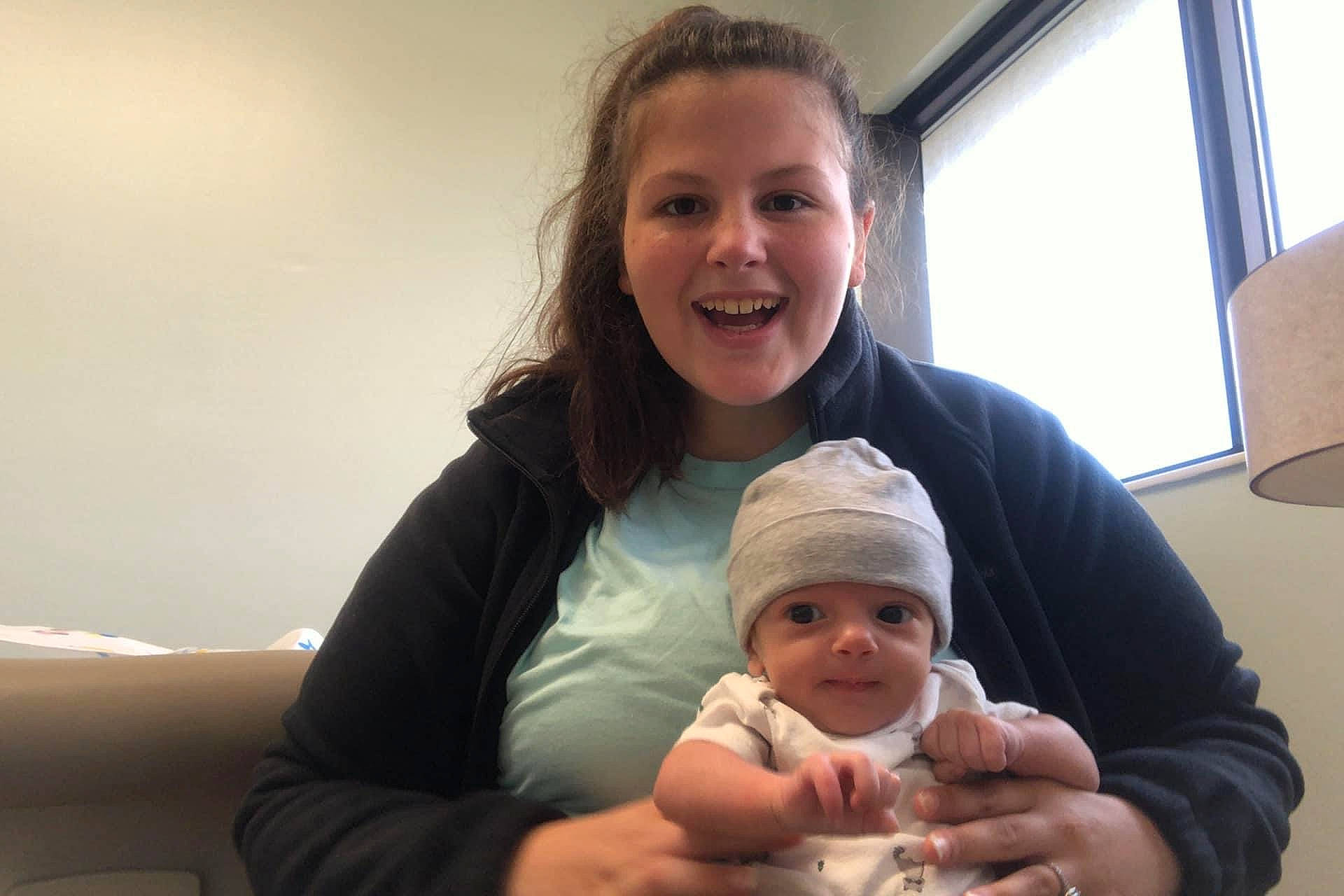 Gabriel is registered to the contest to win money with this photo: baby, baby_products, baby_toddler_clothing, beanie, blond, bonnet, cheek, child, comfort, daylighting, face, hand, happy, headwear, human, joy, knit_cap, person, skin, toddler