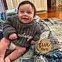 Hudsyn joined the competition — help win amazing prizes! baby, infant, smiling, milestone_sign, five_months, sweater, quilt, blanket, diaper, toes, indoors, kitchen, cabinet, hardwood_floor, rug, portrait, cozy, happy, sitting, wooden_sign