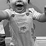 Hudsyn joined the competition — help win amazing prizes! baby, toddler, child, smiling, happy, portrait, black_and_white, overalls, elephant_patch, face, eyes, mouth, hair, arms, standing, indoor, wall, baseboard, wooden_floor, clothing