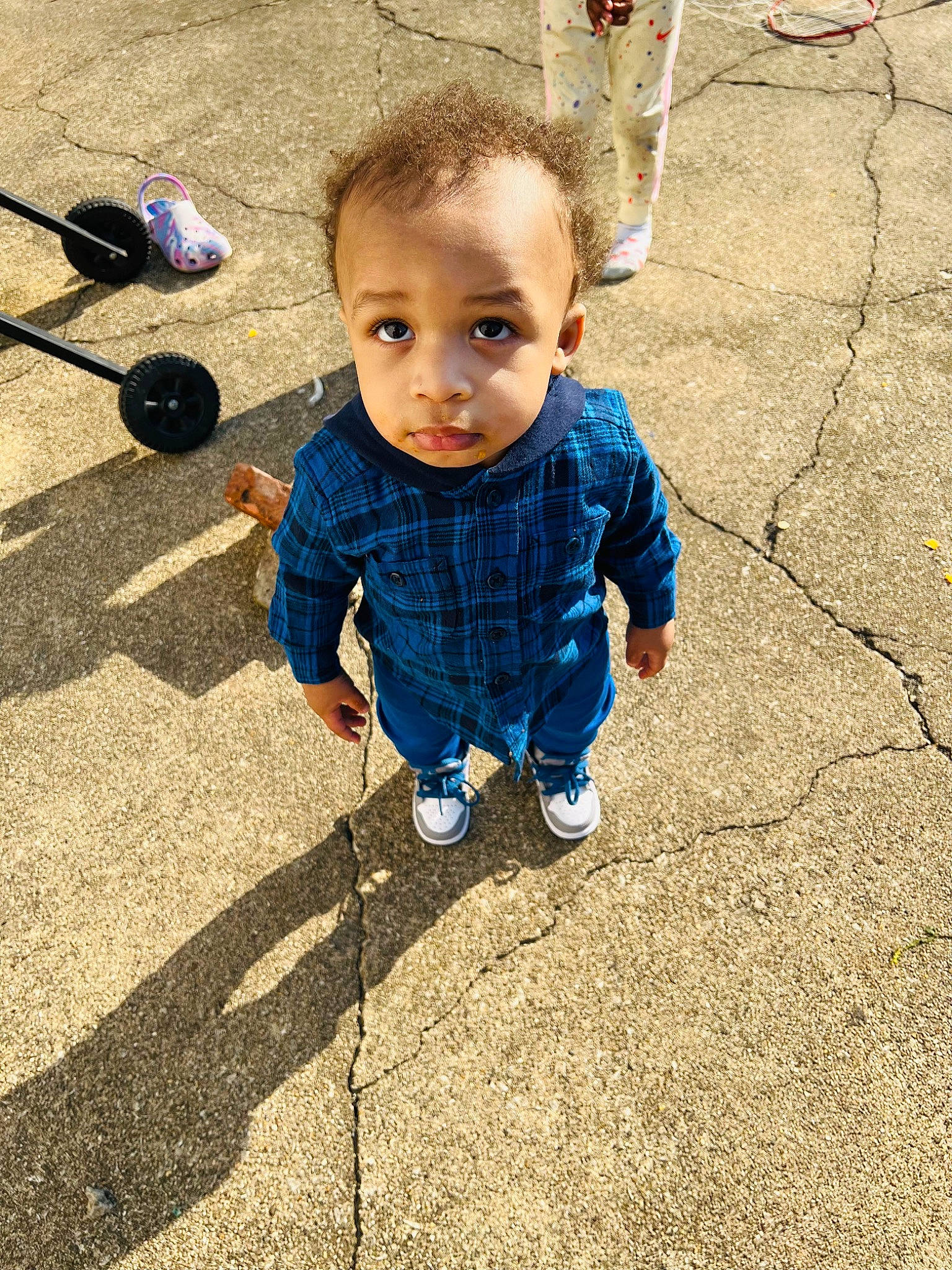 Matthew is registered to the contest to win money with this photo: asphalt, baby, baby_toddler_clothing, child, electric_blue, floor, flooring, fun, grass, hair, people_in_nature, person, road_surface, shoe, sidewalk, sitting, smile, sneakers, soil, toddler