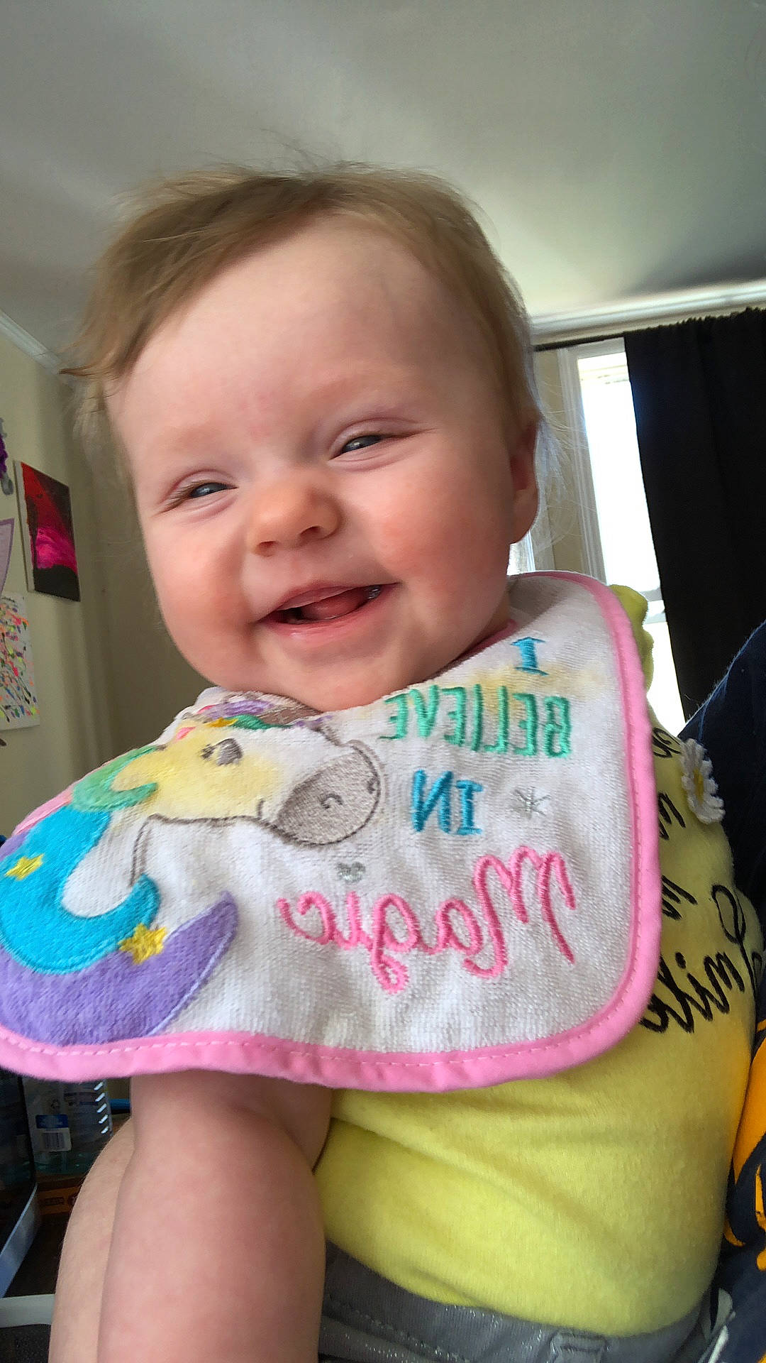 Shai is registered to the contest to win money with this photo: baby, baby_products, baby_toddler_clothing, blond, cheek, child, curtain, eye, iris, laugh, person, pink, sock, toddler, tongue, tooth