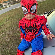 Christian joined the competition — help win amazing prizes! child, toddler, costume, spiderman_costume, mask, face, sneakers, car_trunk, car, grass, lawn, suburban, driveway, sunset, portrait, sitting, outdoor, holiday_costume, street, playful