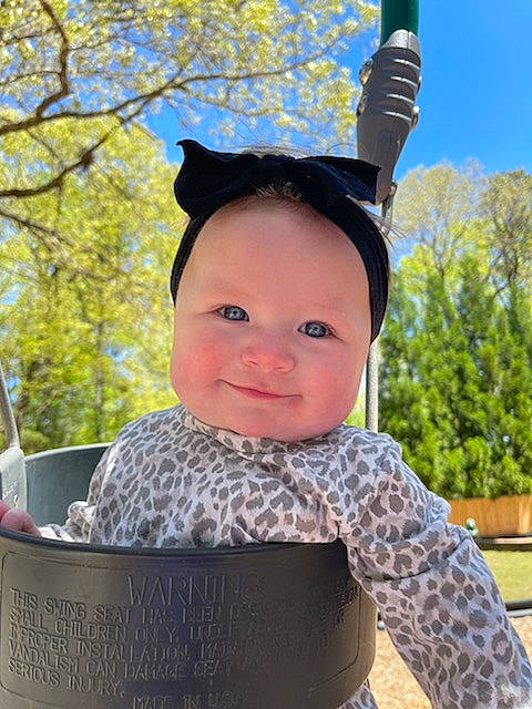 Taytum joined the competition — help win amazing prizes! baby, baby_products, baby_toddler_clothing, child, eye, face, fashion_accessory, fun, grass, happy, head, headwear, human_body, joy, leisure, pattern, person, personal_protective_equipment, recreation, sitting