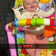 Diana participe au concours pour gagner de l'argent avec cette photo : baby, blanket, bouncer, colorful, emoji_overlay, face, hands, happy, indoor, infant, legs, onesie, piano_toy, play_mat, portrait, remote_control, smiling, snapshot, socks, toy