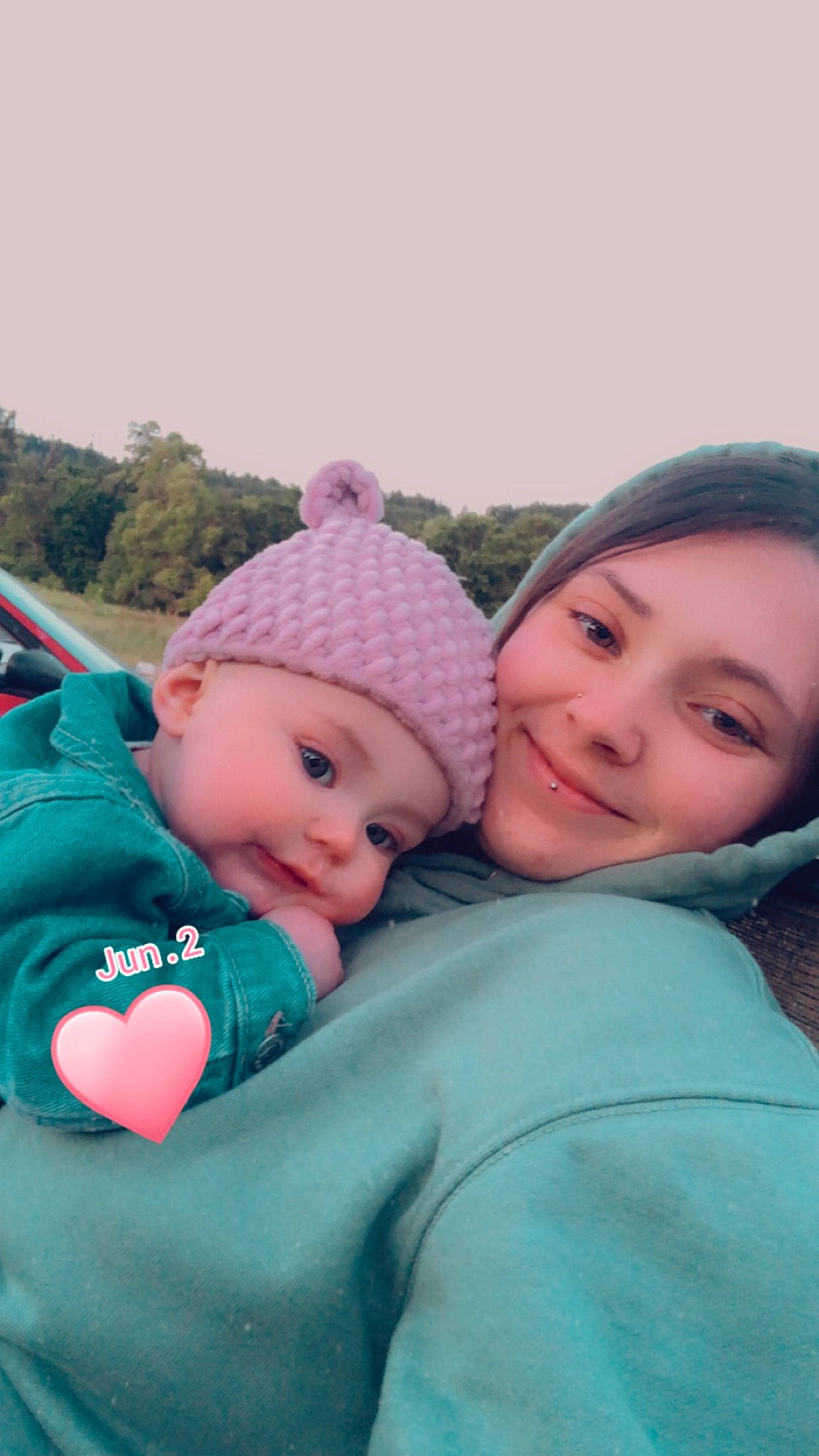 Aliyah is registered to the contest to win money with this photo: baby, baby_toddler_clothing, cap, cheek, eye, face, freezing, fun, grass, happy, head, headwear, interaction, joy, knit_cap, leisure, people_in_nature, person, pink, skin