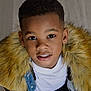 child, boy, portrait, face, smile, denim_jacket, fur_collar, fashion, young, cute, looking_up, black_hair, casual_clothing, indoors, person, head_and_shoulders, happy, warm_clothing, closeup, eyes