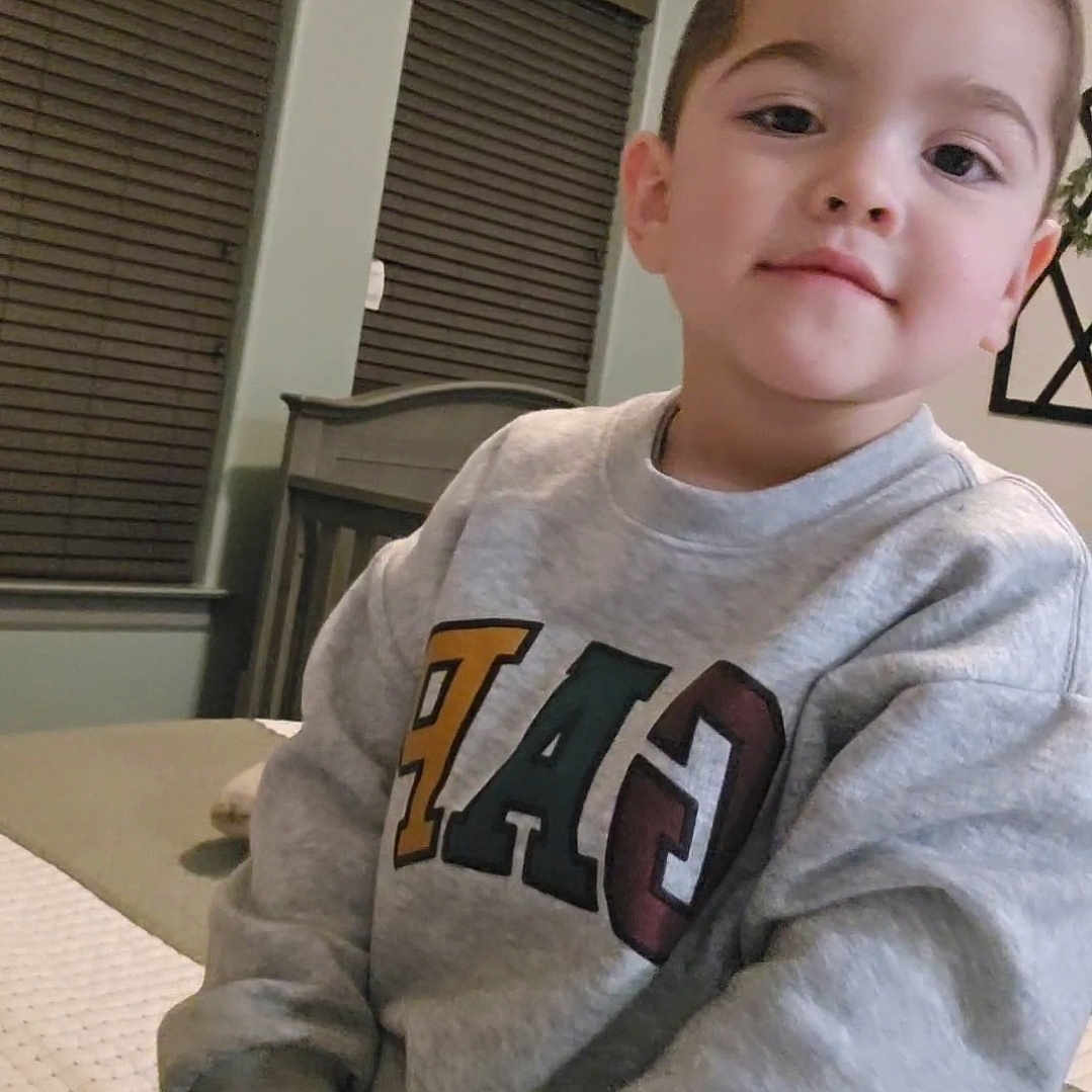 Lauro joined the competition — help win amazing prizes! boy, child, clothing, face, head, homedecor, indoors, knitwear, longsleeve, male, pants, person, photography, portrait, sitting, sleeve, sweater, t_shirt, text, window