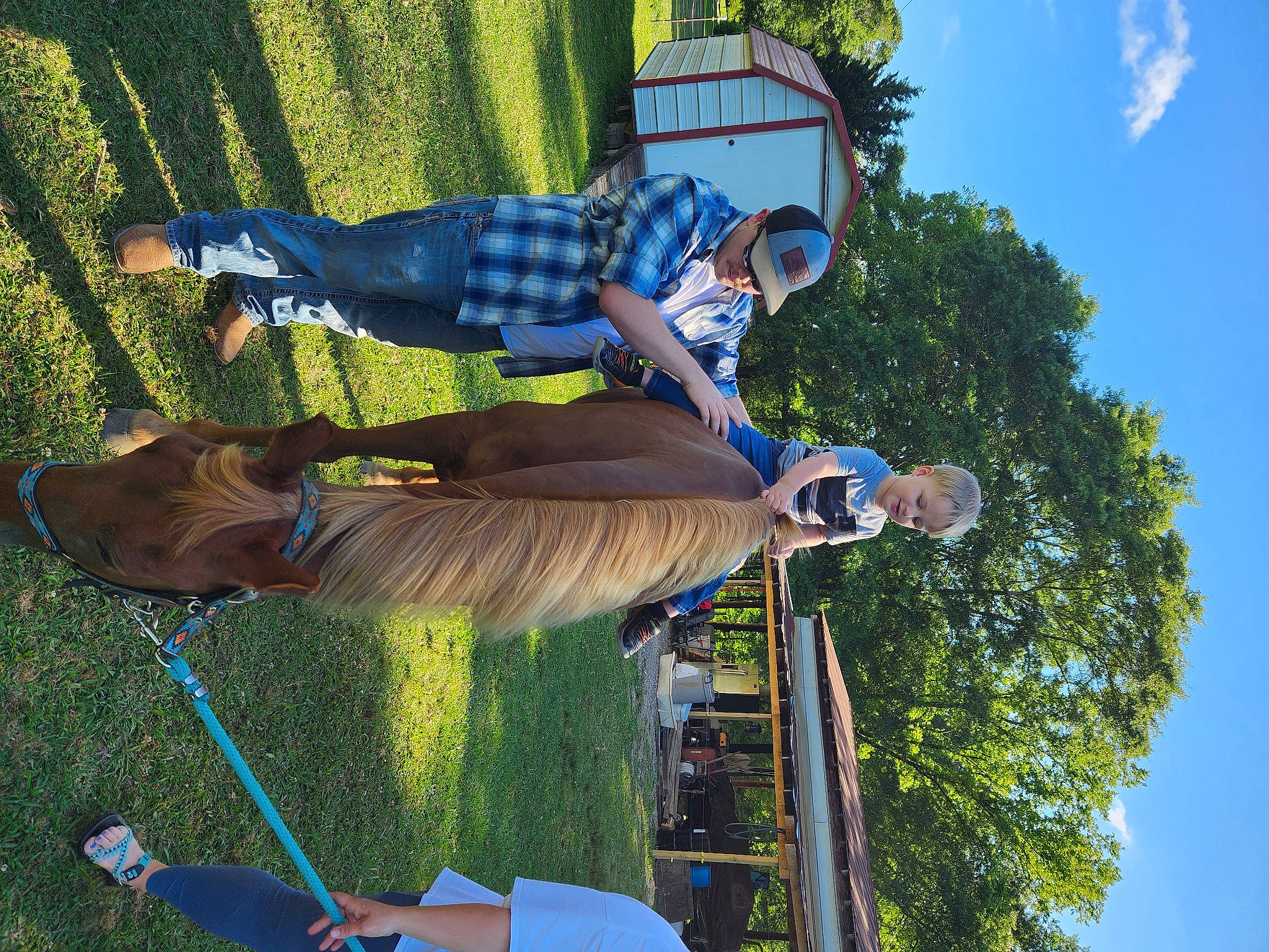 Rowan is registered to the contest to win money with this photo: blue, elbow, electric_blue, fun, grass, hat, leisure, pattern, people_in_nature, person, pole, recreation, sky, t_shirt, tartan, tree