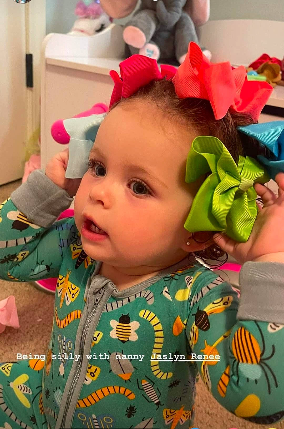 Princess Burleigh is registered to the contest to win money with this photo: baby, baby_toddler_clothing, cheek, child, costume_hat, eye, eyelash, fashion_accessory, flower, fun, hair_accessory, happy, headband, headpiece, pattern, person, petal, pink, plant, play