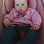 baby, infant, car_seat, seat_belt, pink, sweatshirt, blue_eyes, hands, legs, socks, face, portrait, clothing, buckle, safety, cozy, gaze, cute, cartoon_print, child