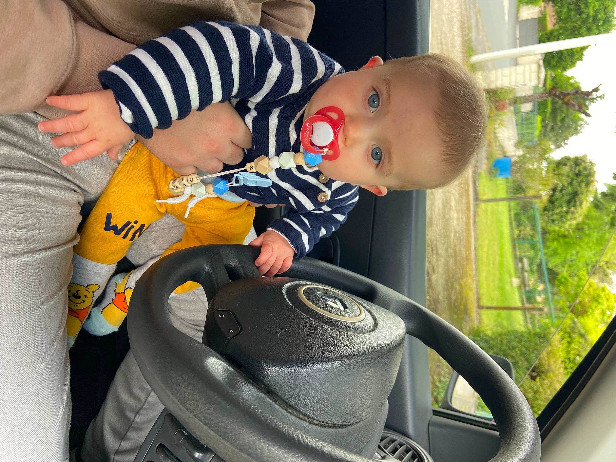 Nolan a rejoint le concours — aidez-le/la à gagner de superbes lots ! audio_equipment, auto_part, automotive_design, automotive_exterior, automotive_tire, automotive_wheel_system, baby, baby_carriage, baby_products, baby_toddler_clothing, child, grass, happy, light, motor_vehicle, person, plant, steering_wheel, toddler, vehicle