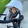 Raylan joined the competition — help win amazing prizes! baby, stroller, child, outdoor, sidewalk, grass, curious, infant, canopy, wheels, black_clothing, modern, seat, person, young_child, baby_girl_or_boy, daylight, pavement, casual, transportation