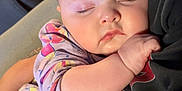 Jessica joined the competition — help win amazing prizes! baby, sleeping, child, infant, person, closeup, face, arm, hand, clothing, sleeve, pattern, fabric, rest, comfort, couch, indoor, soft_light, peaceful, tender