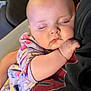 baby, sleeping, child, infant, person, closeup, face, arm, hand, clothing, sleeve, pattern, fabric, rest, comfort, couch, indoor, soft_light, peaceful, tender
