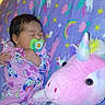 baby, bedtime, blanket, child, colorful, cozy, cute, indoor, infant, newborn, pacifier, pajamas, patterned, plush_toy, resting, sleeping, soft, stuffed_animal, toy, unicorn