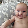 baby, infant, child, smiling, portrait, close_up, lying_down, diaper, blanket, bedding, elephant_pattern, nursery, home, indoors, face, eyes, skin, happy, cute, photography