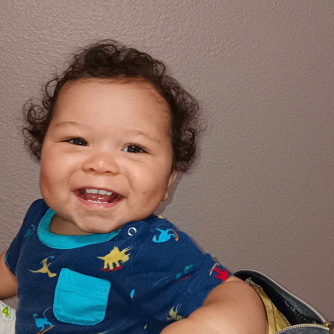 King is registered to the contest to win money with this photo: accessories, baby, babylaughing, bag, bodypart, clothing, dress, face, finger, hand, happy, head, laughing, mouth, pants, person, photography, portrait, smile, teeth