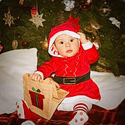 élena a rejoint le concours — aidez-le/la à gagner de superbes lots ! baby, christmas, holiday, festive, santa_claus, red_clothing, gift_bag, christmas_tree, ornaments, decorations, toddler, striped_tights, white_background, plush, cute, indoors, celebration, holiday_season, child, festive_outfit